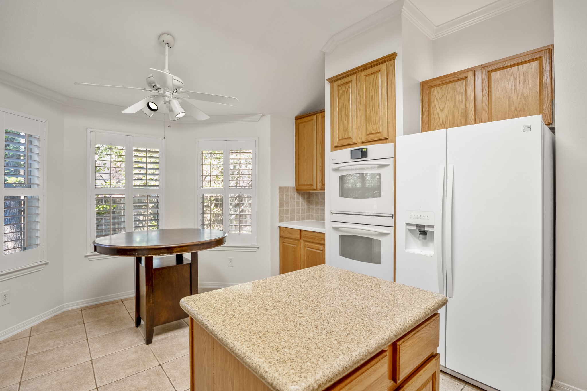 15 Heron Hollow Court Spring, TX 77382 - Photo 14 of 42 a kitchen with stainless steel appliances a stove a refrigerator white cabinets and wooden floor