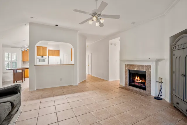 a view of an empty room with window and fireplace