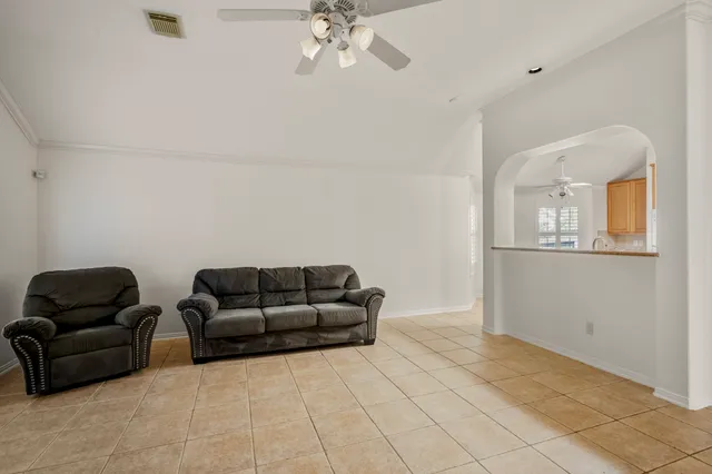 a living room with furniture and a mirror