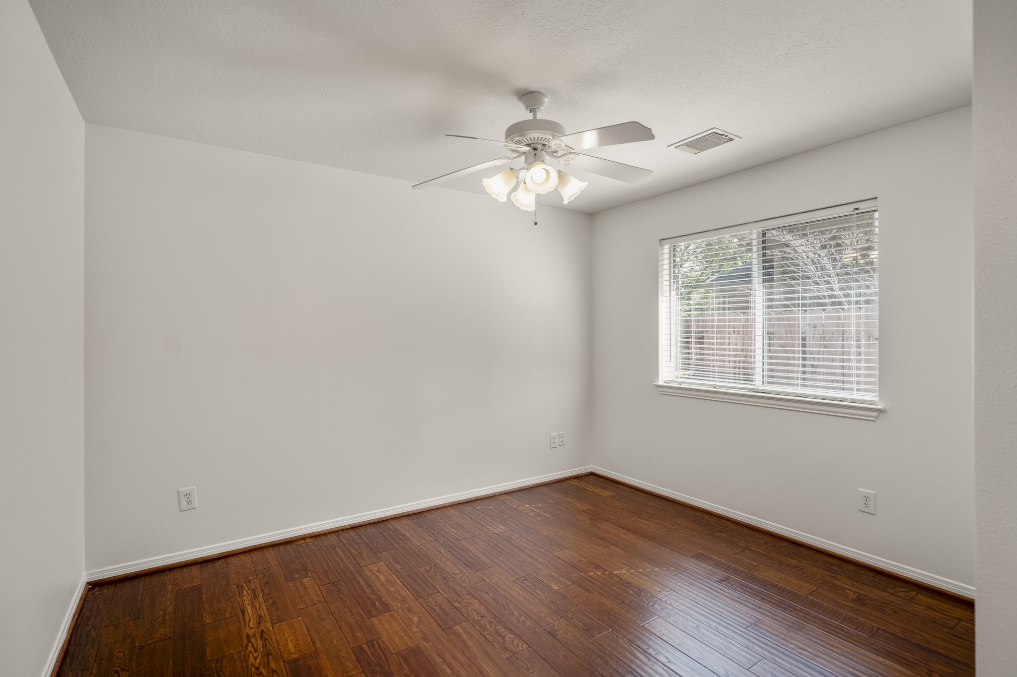15 Heron Hollow Court Spring, TX 77382 - Photo 23 of 42 wooden floor in an empty room with a window