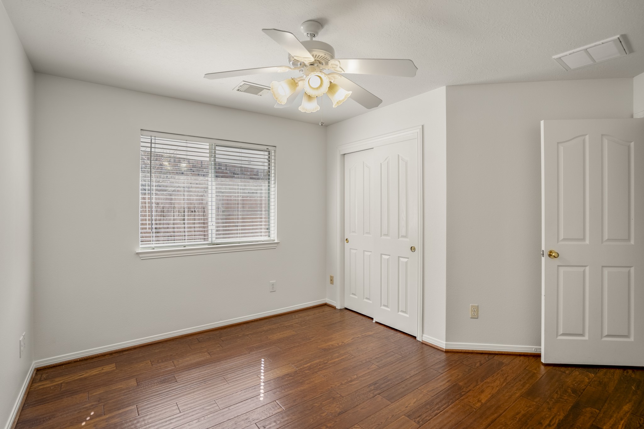 15 Heron Hollow Court Spring, TX 77382 - Photo 24 of 42 a view of an empty room with wooden floor and a window