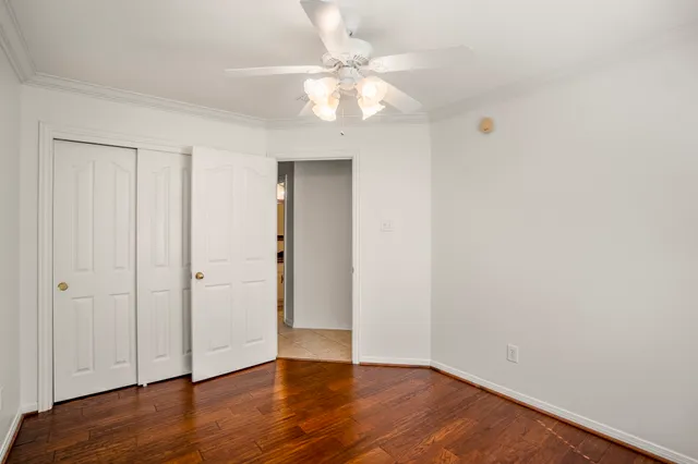 a view of an empty room with wooden floor