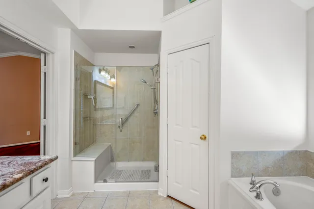 a bathroom with a granite countertop sink a toilet and shower