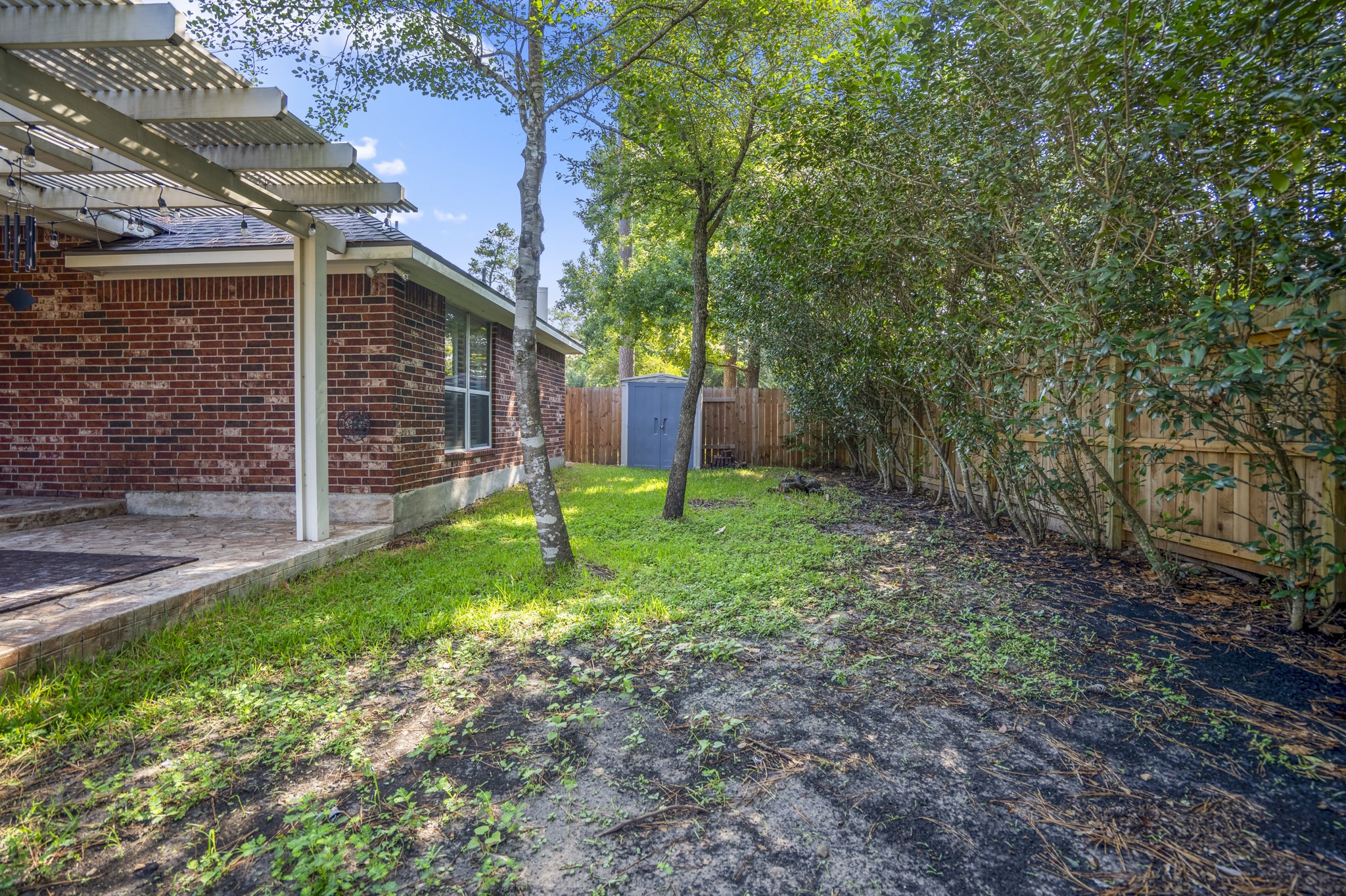 15 Heron Hollow Court Spring, TX 77382 - Photo 40 of 42 a view of a backyard with a garden