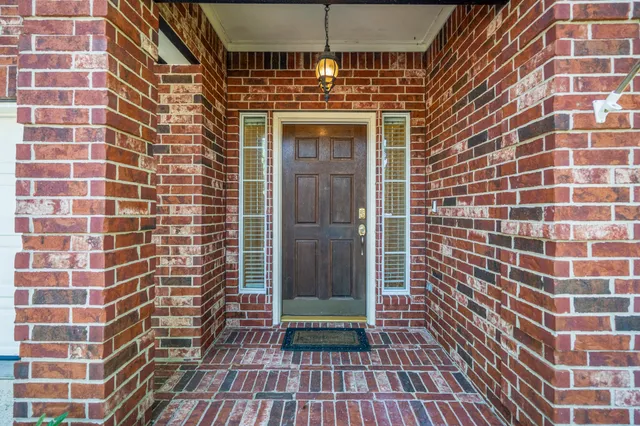 a view of a brick building with glass door
