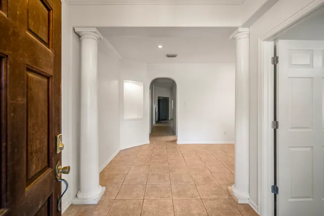 a view of a hallway to an empty room