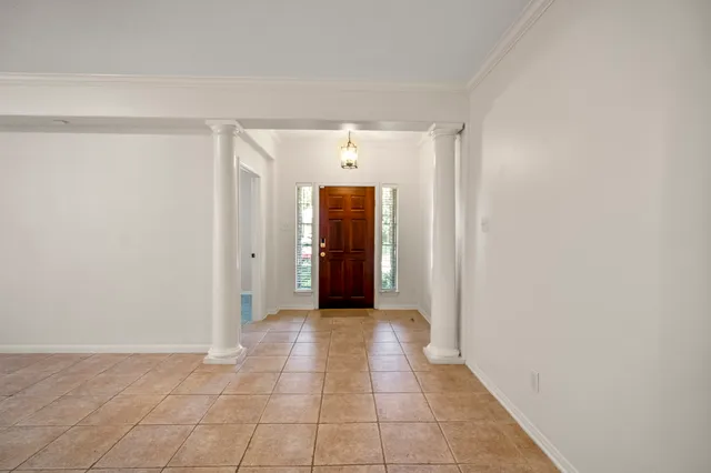 a view of a hallway with wooden shelves