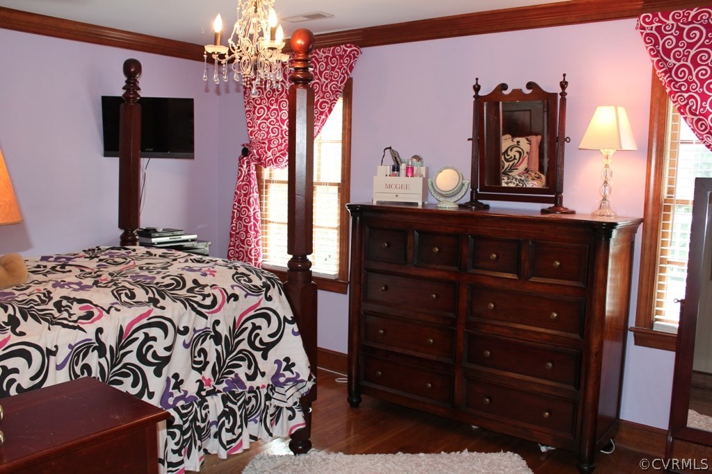 207 Rivers Bend Circle Chester, VA 23836 - Photo 20 of 36 a bedroom with a bed and a flat tv screen on dresser