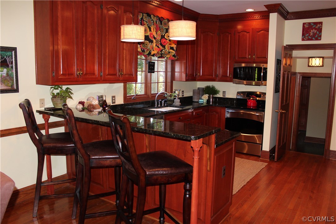 207 Rivers Bend Circle Chester, VA 23836 - Photo 7 of 36 a view of a dining room with furniture and wooden floor