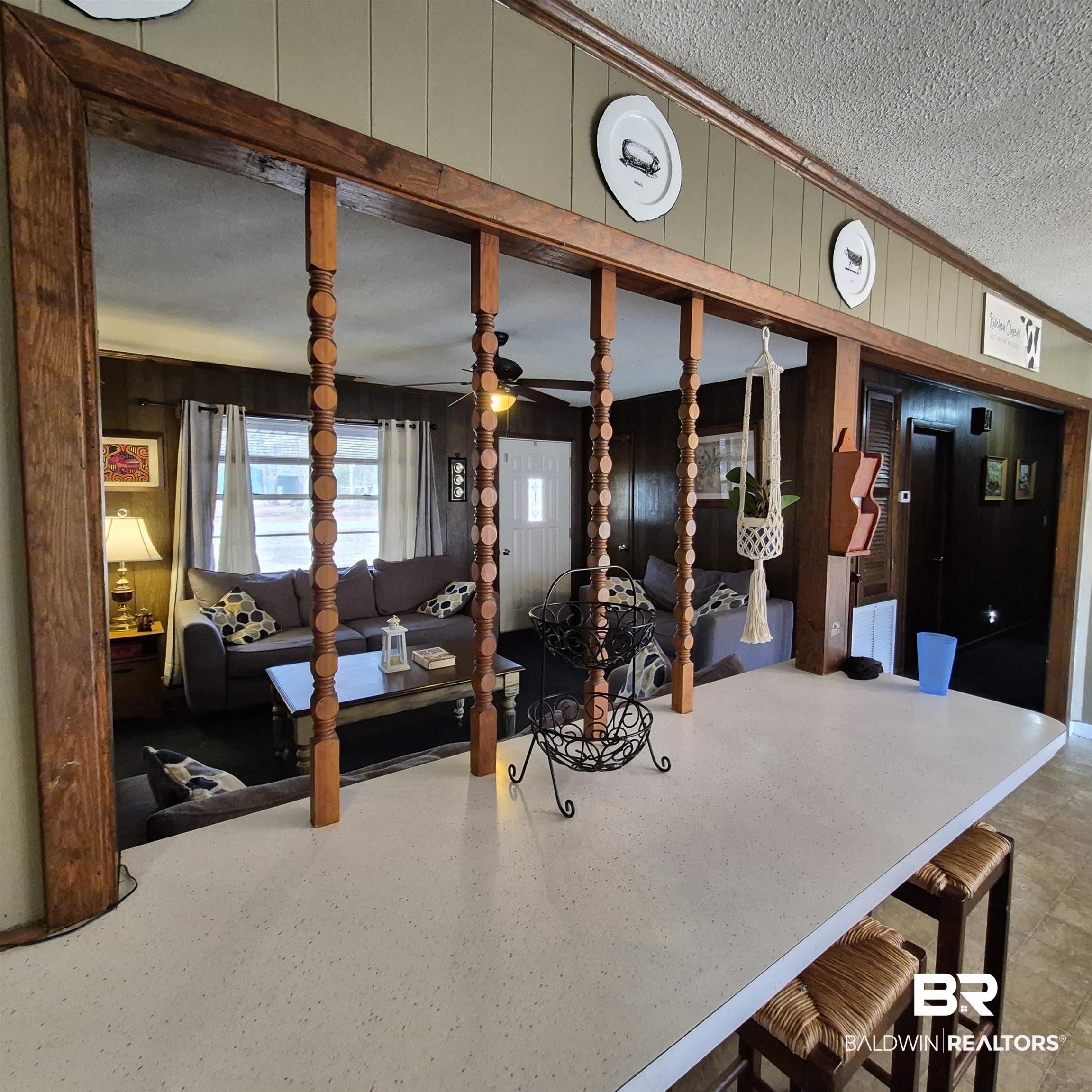 491 Forrest Avenue Castleberry, AL 36432 - Photo 8 of 33 Interior space with a textured ceiling, ceiling fan, wood walls, and ornamental molding