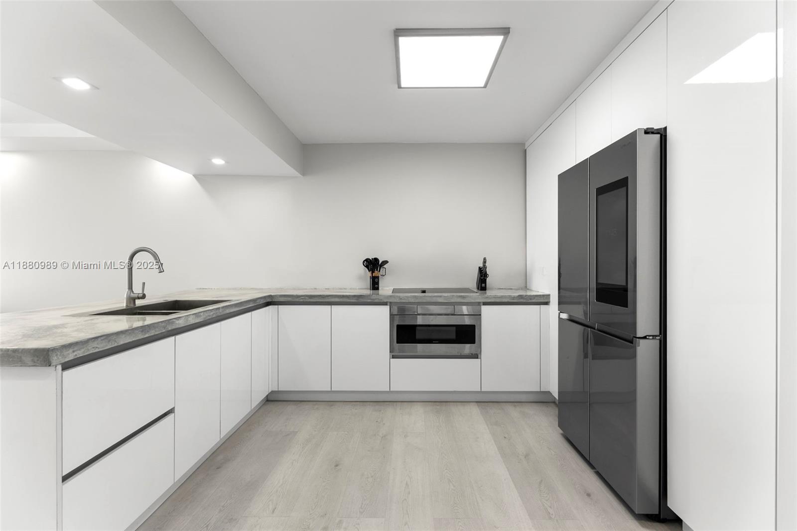 400 North Surf Road, Unit 903 Hollywood, FL 33019 - Photo 34 of 34 a kitchen with stainless steel appliances granite countertop a sink and cabinets