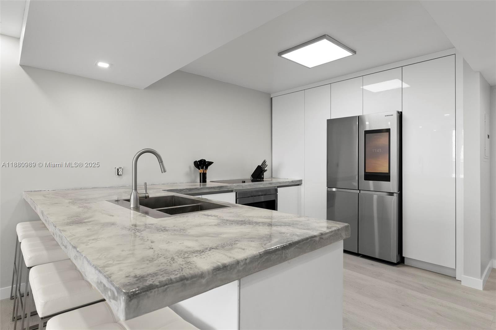 400 North Surf Road, Unit 903 Hollywood, FL 33019 - Photo 4 of 34 a kitchen with stainless steel appliances granite countertop a refrigerator and a sink