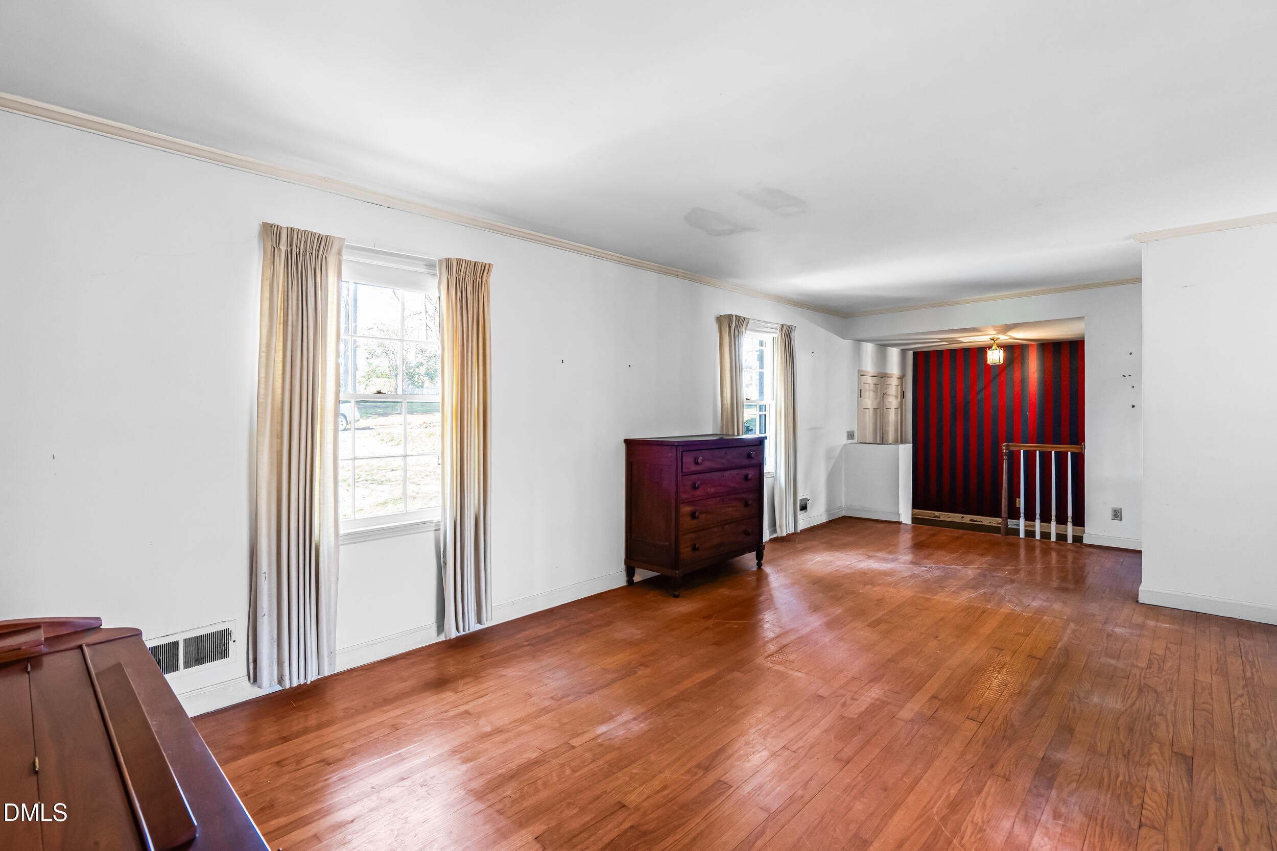 4208 Redington Drive Raleigh, NC 27609 - Photo 9 of 45 a view of an empty room with window and wooden floor