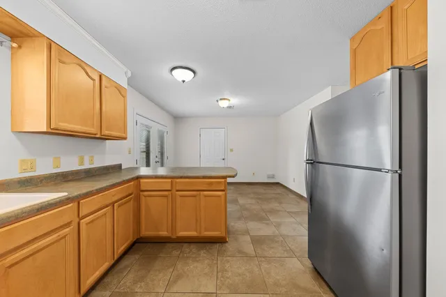a kitchen with stainless steel appliances granite countertop a refrigerator sink and cabinets