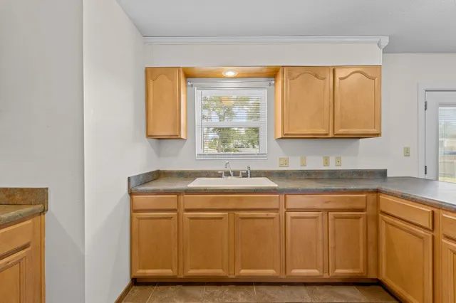 a view of a sink and dishwasher with wooden floor