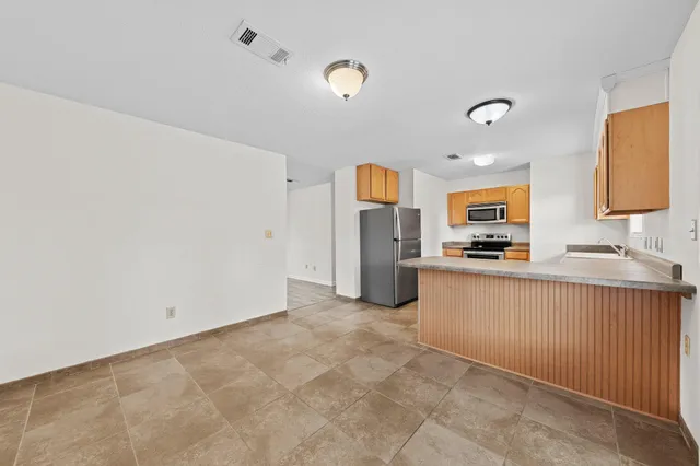 a kitchen with stainless steel appliances a refrigerator and a sink