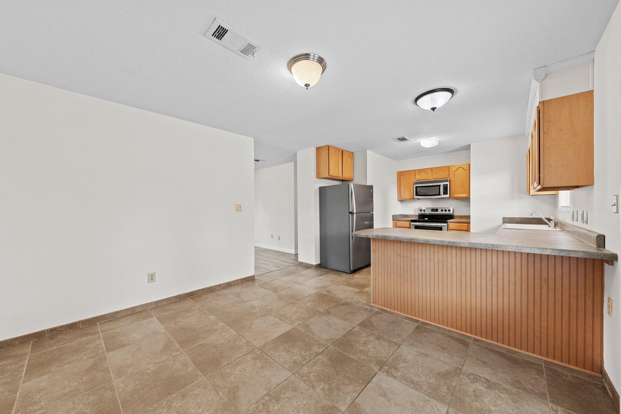 309 23rd Street Niceville, FL 32578 - Photo 17 of 33 a kitchen with stainless steel appliances a refrigerator and a sink