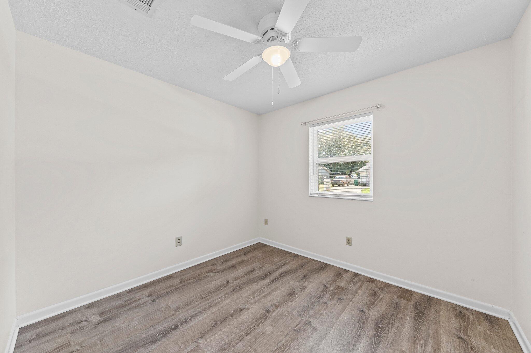 309 23rd Street Niceville, FL 32578 - Photo 21 of 33 an empty room with a window and a fan