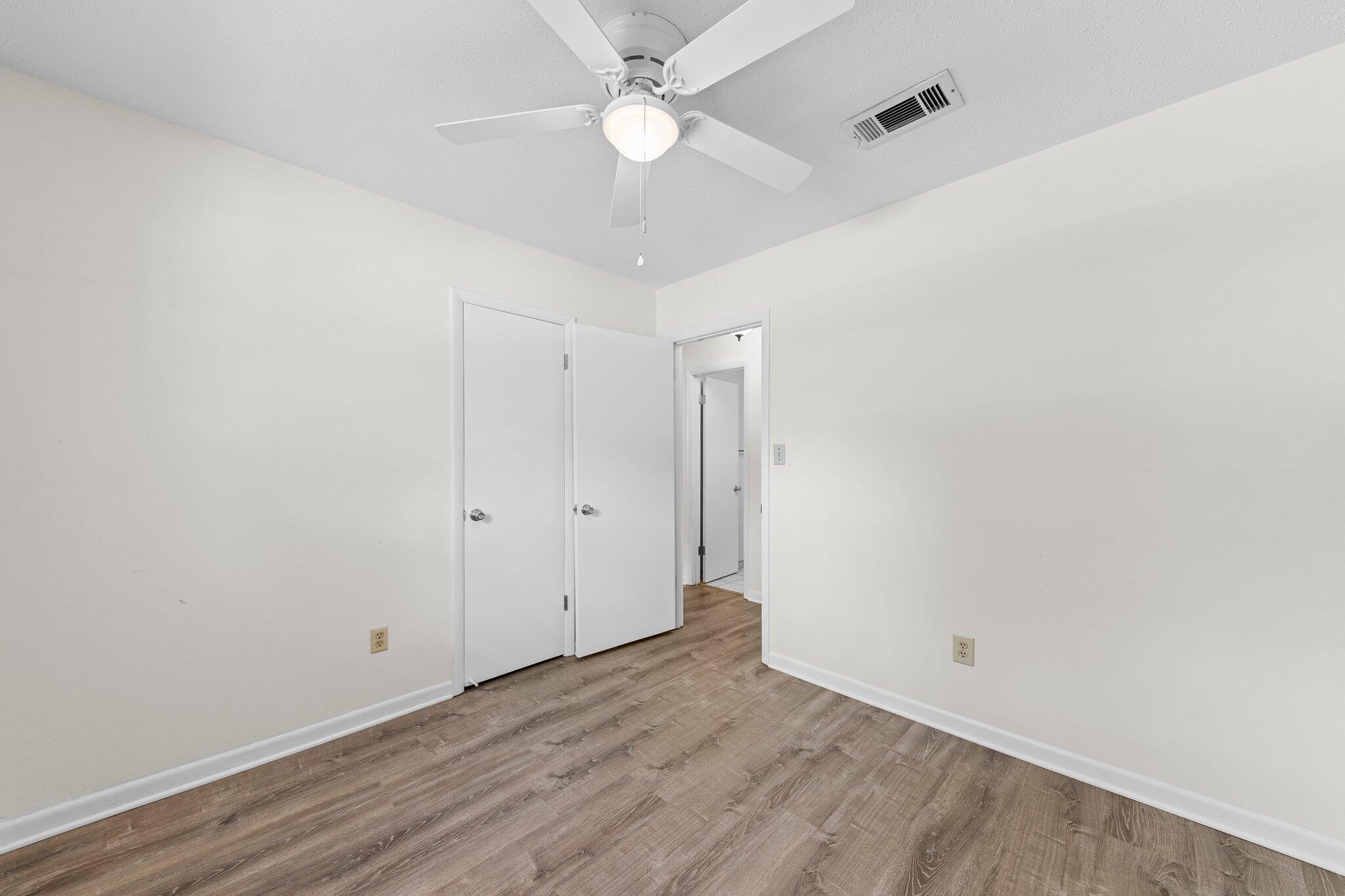 309 23rd Street Niceville, FL 32578 - Photo 22 of 33 wooden floor in an empty room