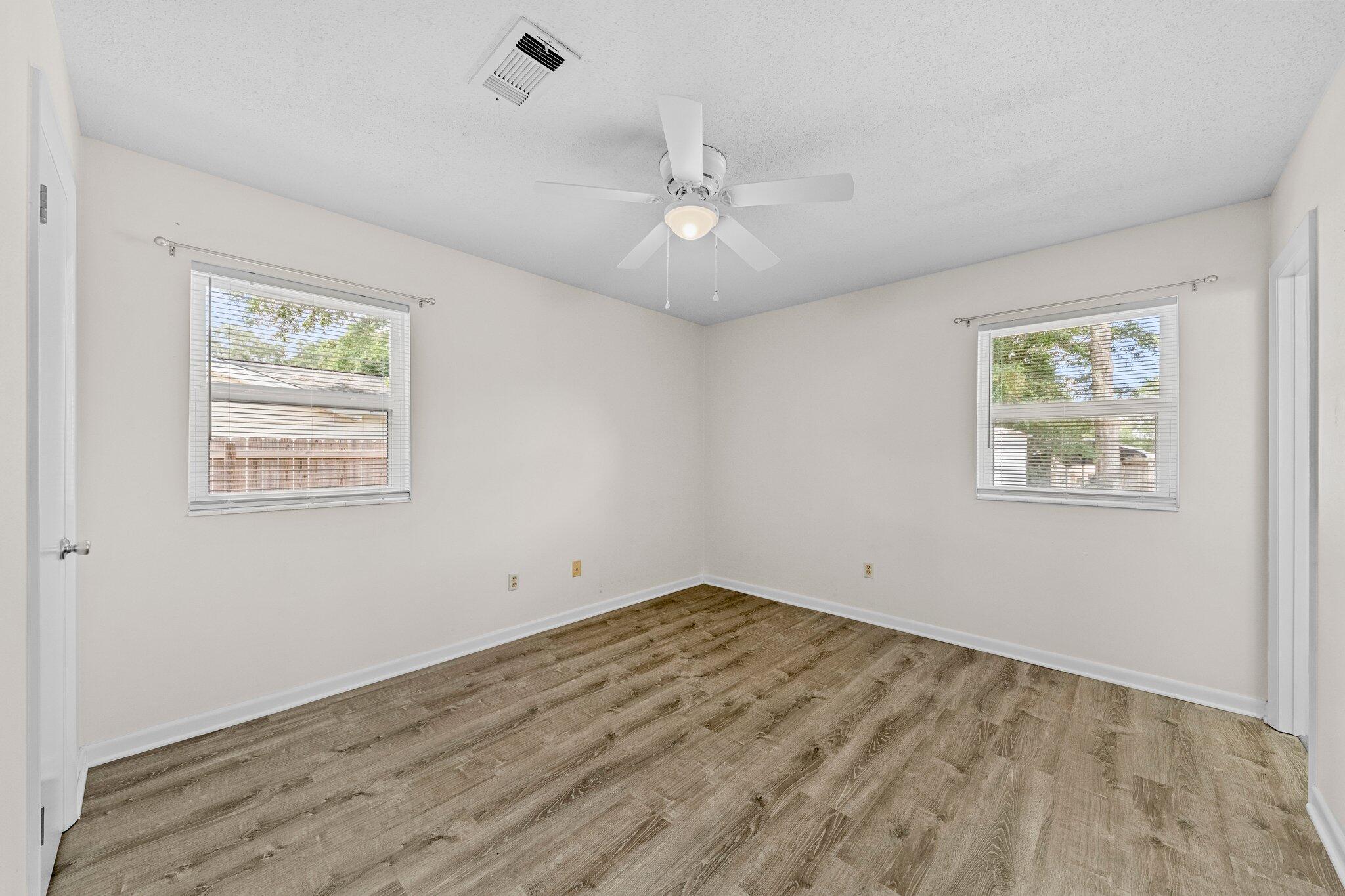 309 23rd Street Niceville, FL 32578 - Photo 24 of 33 a view of empty room with wooden floor