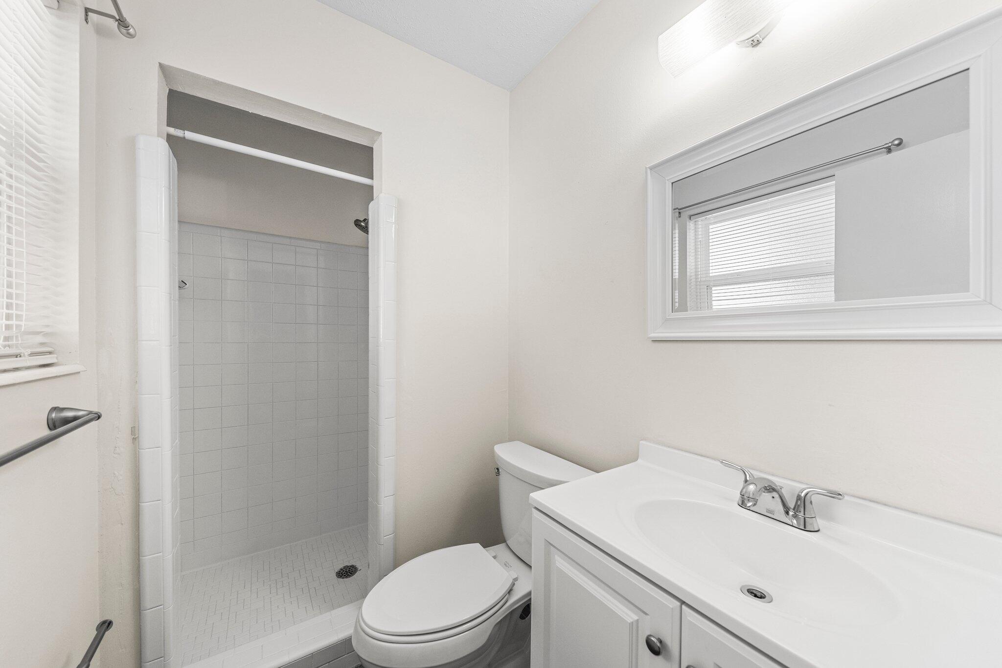 309 23rd Street Niceville, FL 32578 - Photo 26 of 33 a bathroom with a sink a toilet and shower