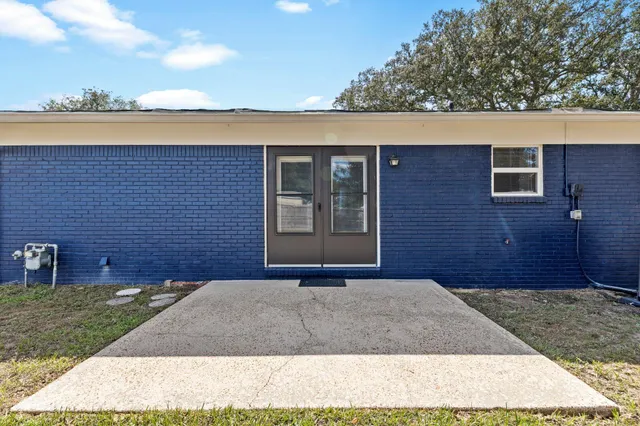 a view of a brick house with a yard