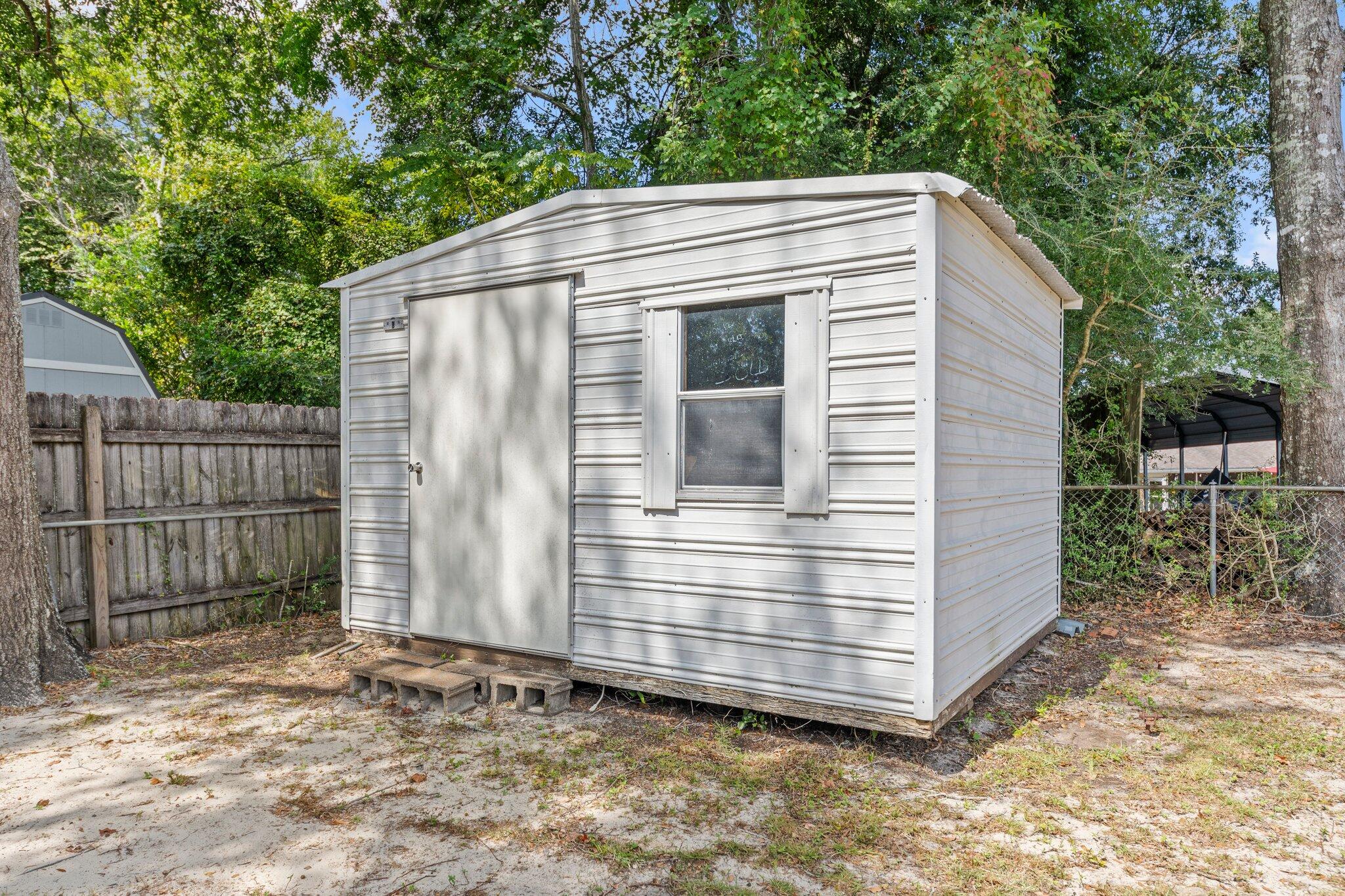 309 23rd Street Niceville, FL 32578 - Photo 29 of 33 a view of house with wooden fence and large trees