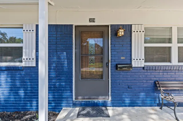 a brick building with a door and a window