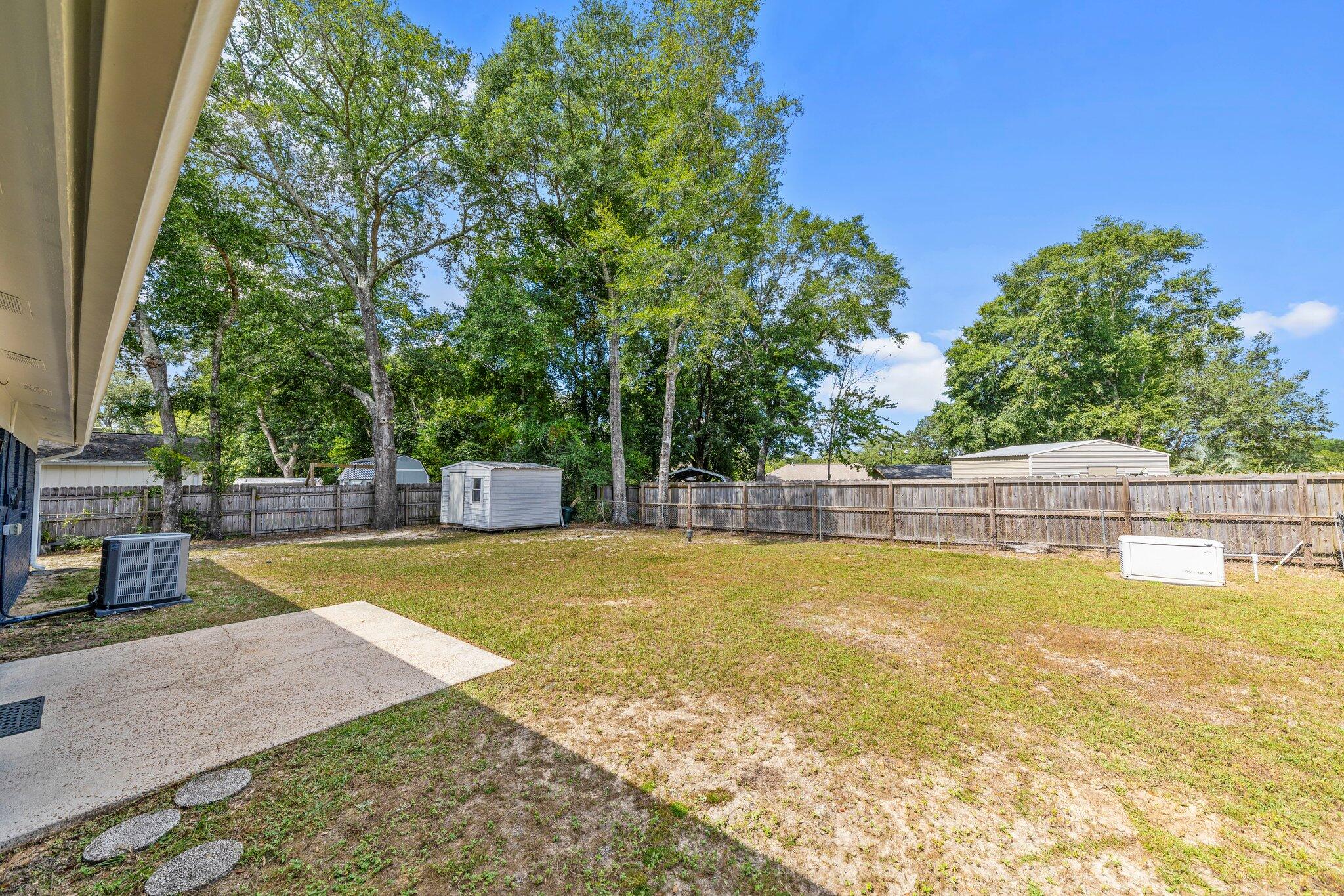 309 23rd Street Niceville, FL 32578 - Photo 32 of 33 a view of a swimming pool with an outdoor seating and a yard