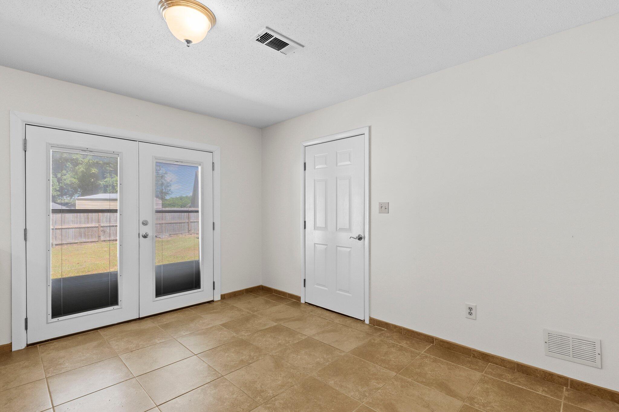 309 23rd Street Niceville, FL 32578 - Photo 9 of 33 a view of an empty room with a window