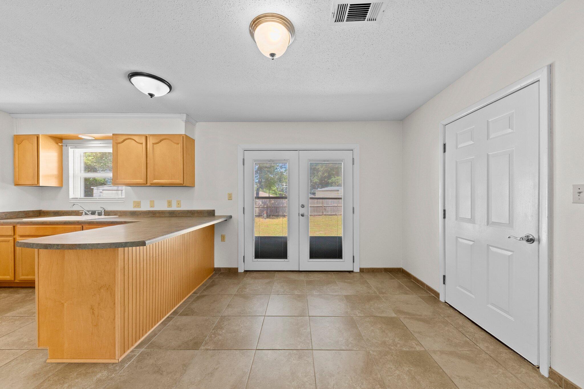 309 23rd Street Niceville, FL 32578 - Photo 10 of 33 a spacious bathroom with a tub sink and mirror