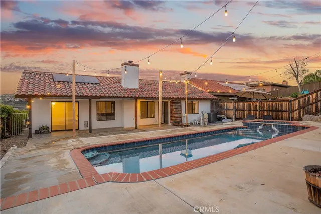 a view of a swimming pool with a chair and tables