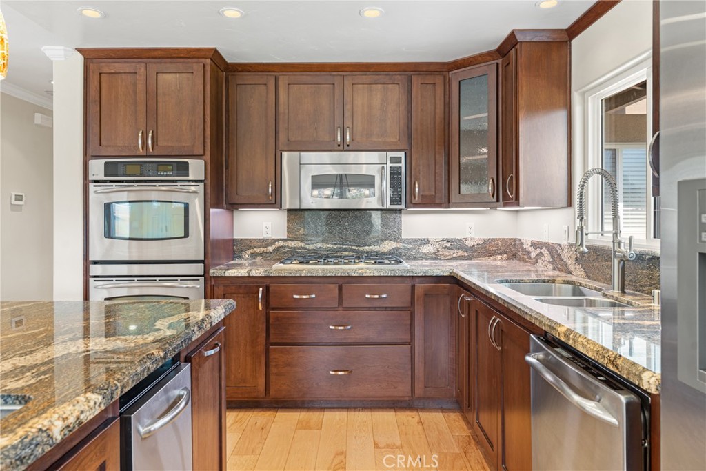 30300 Live Oak Canyon Road Redlands, CA 92373 - Photo 46 of 67 a kitchen with granite countertop stainless steel appliances a stove sink and cabinets