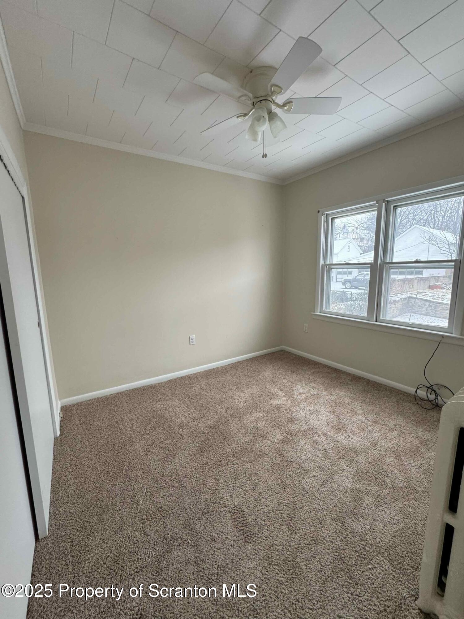 1406 Penn Avenue Scranton, PA 18509 - Photo 12 of 12 an empty room with windows and fan