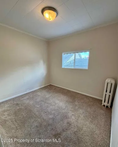 an empty room with a piano