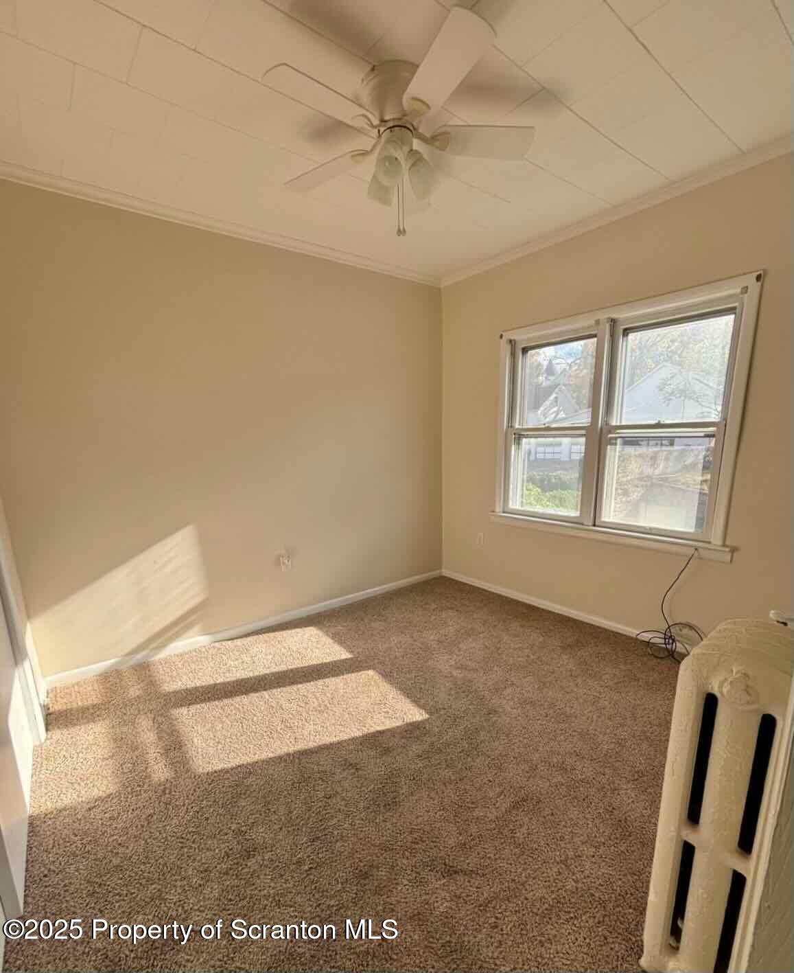 1406 Penn Avenue Scranton, PA 18509 - Photo 8 of 12 an empty room with windows and fan