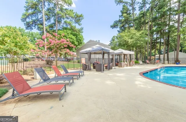 a view of patio with swimming pool table and chairs