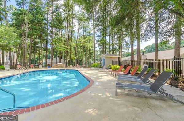 a view of a house with swimming pool and sitting area