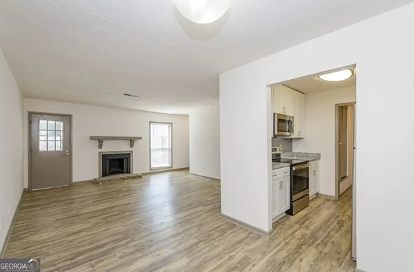 a view of a kitchen with a stove cabinets and wooden floor