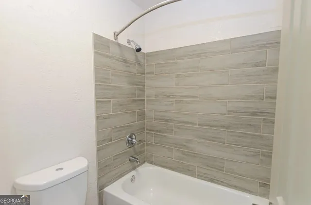 a bathroom with a bathtub and a toilet