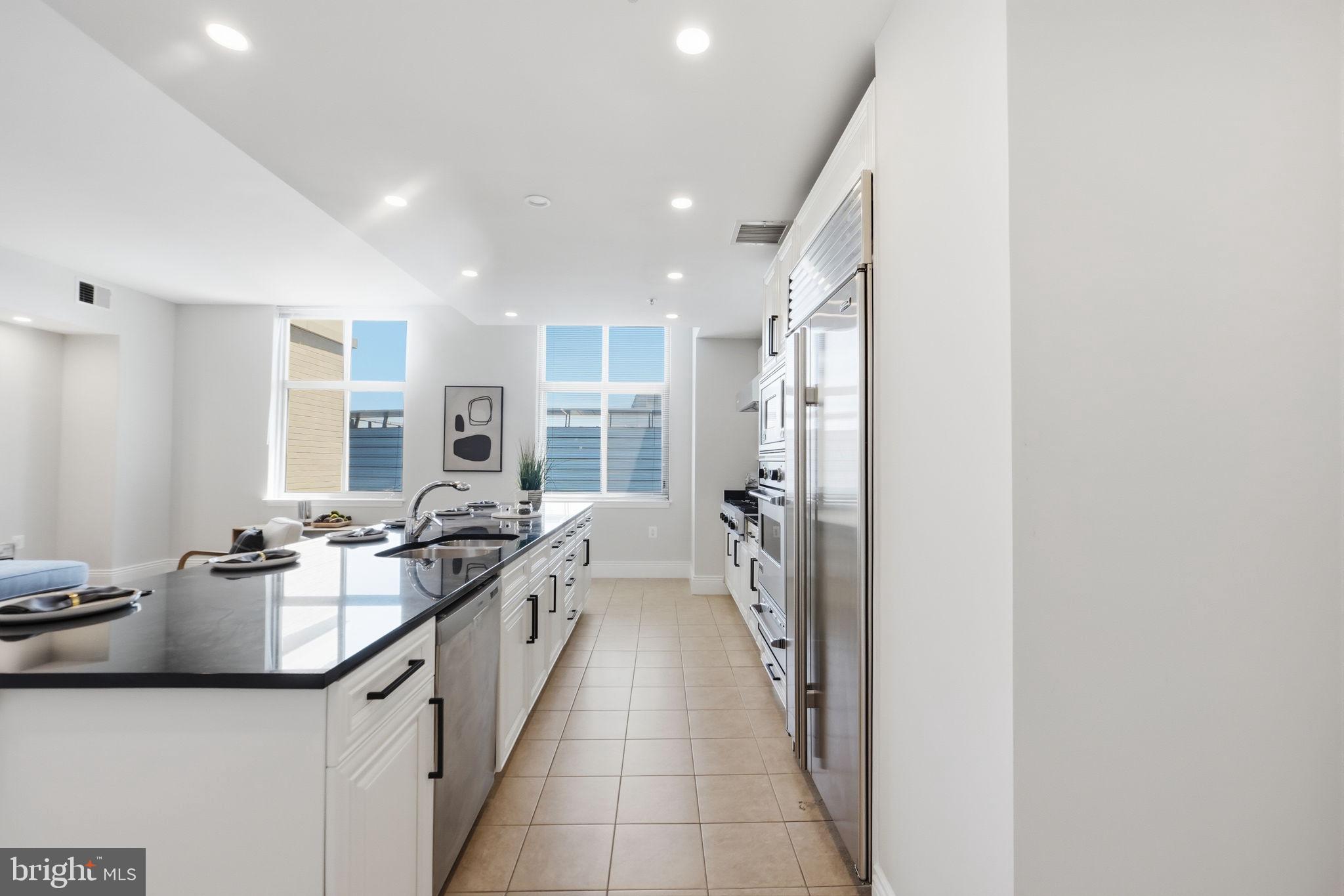 11990 Market Street, Unit 2103 Reston, VA 20190 - Photo 9 of 78 Sleek modern kitchen with natural light.