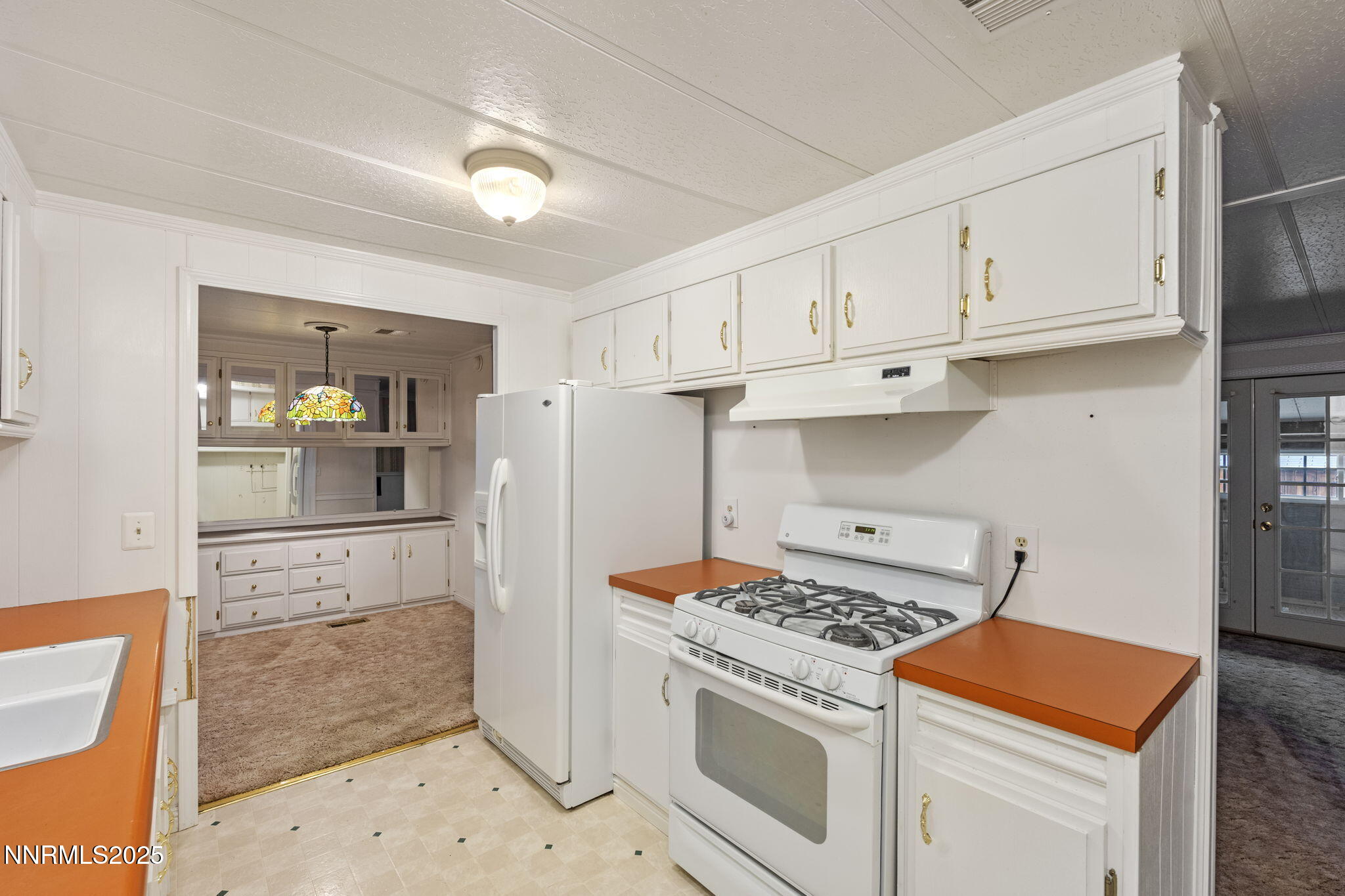 180 Staci Way Sun Valley, NV 89433 - Photo 25 of 71 a kitchen with stainless steel appliances granite countertop a stove and a refrigerator