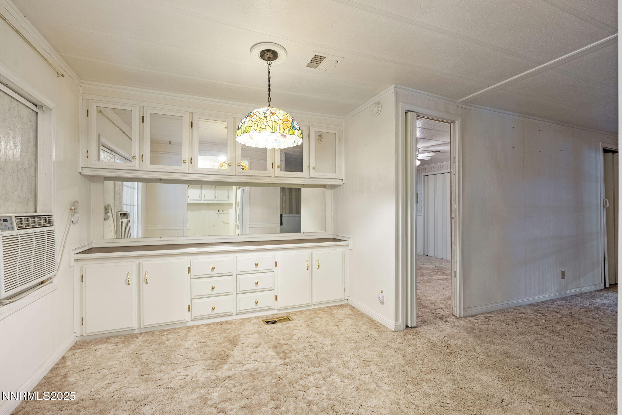 180 Staci Way Sun Valley, NV 89433 - Photo 27 of 71 a kitchen with granite countertop white cabinets and refrigerator