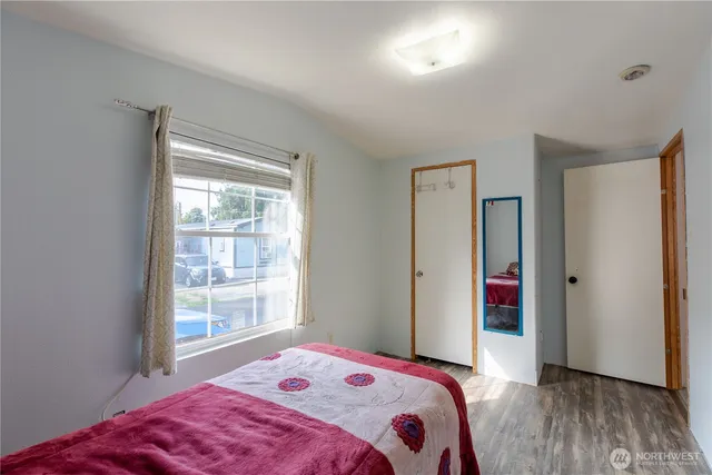 a bedroom with a bed and a window