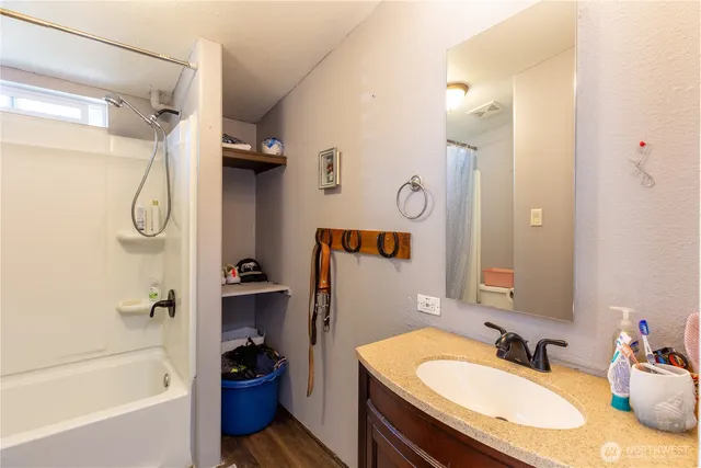a bathroom with a granite countertop sink toilet and shower