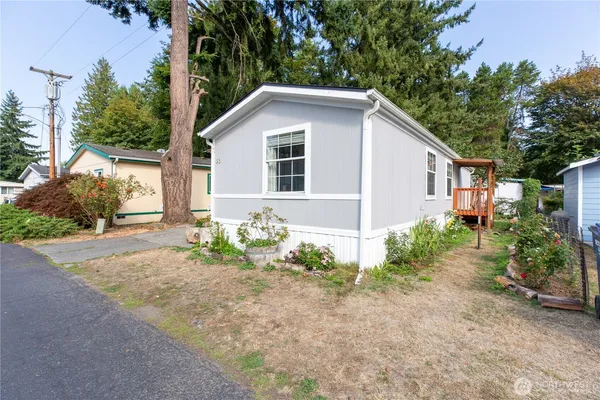 a view of a house with yard and a garden