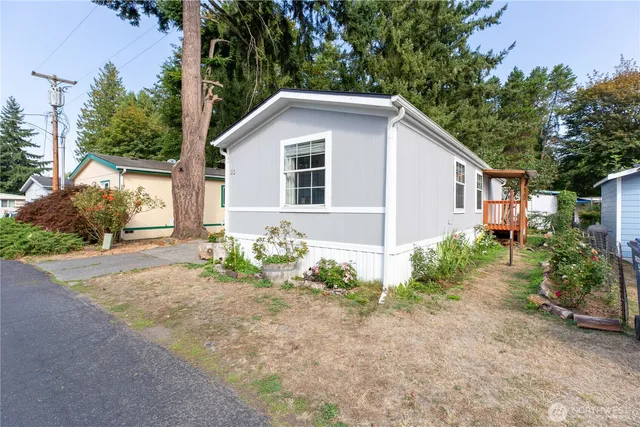 a view of a house with yard and a garden