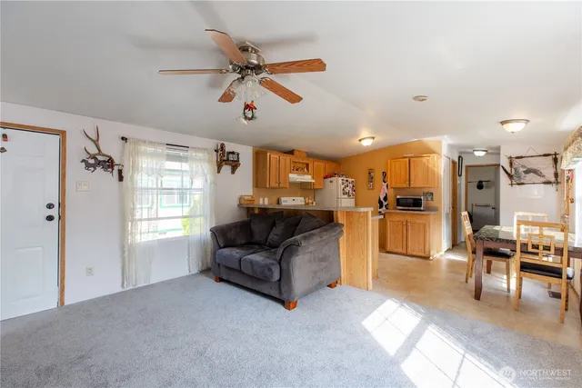 a living room with furniture and kitchen view