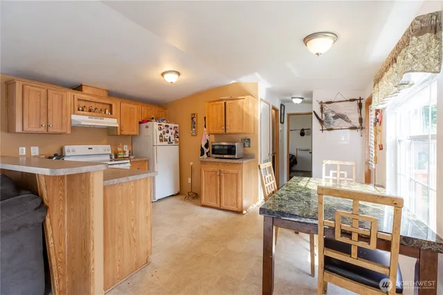 a kitchen with stainless steel appliances granite countertop a refrigerator and stove