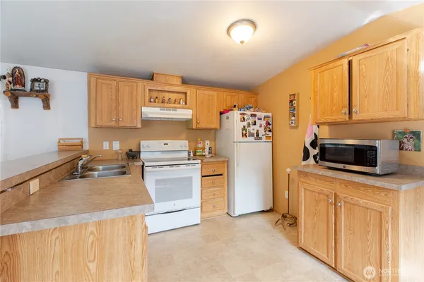 a kitchen with stainless steel appliances a refrigerator sink and stove